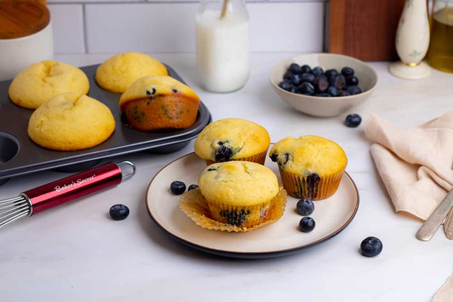 Blueberry muffins on a plate with fresh blueberries