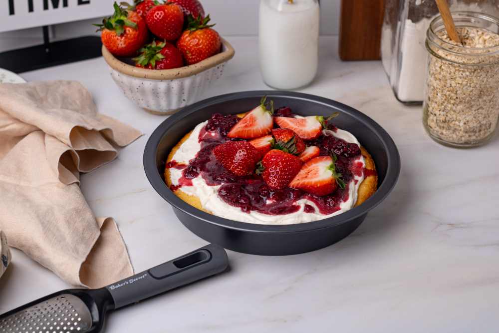 Berry shortcake layer cake with fresh strawberries in a round pan