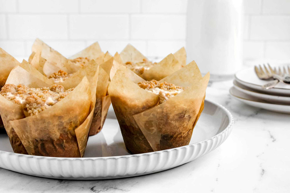 Pumpkin cheesecake crumble muffins in paper tulip liners