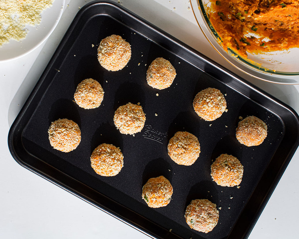 Sweet potato croquettes on a non-stick baking sheet