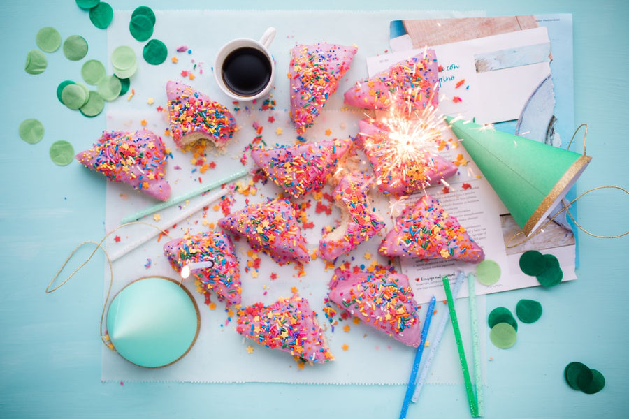 Sprinkle-covered party treats with colorful party hats