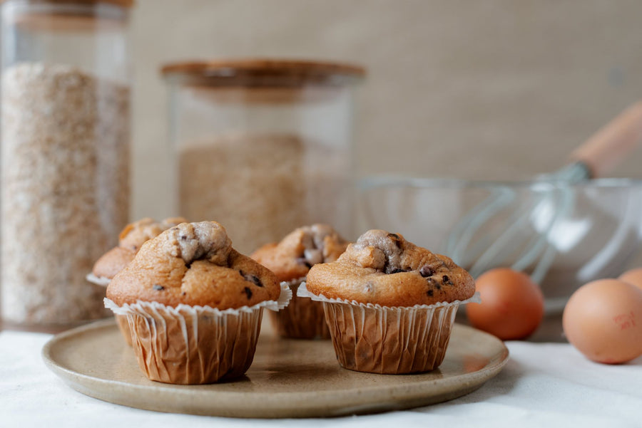 Freshly baked muffins on a wooden board