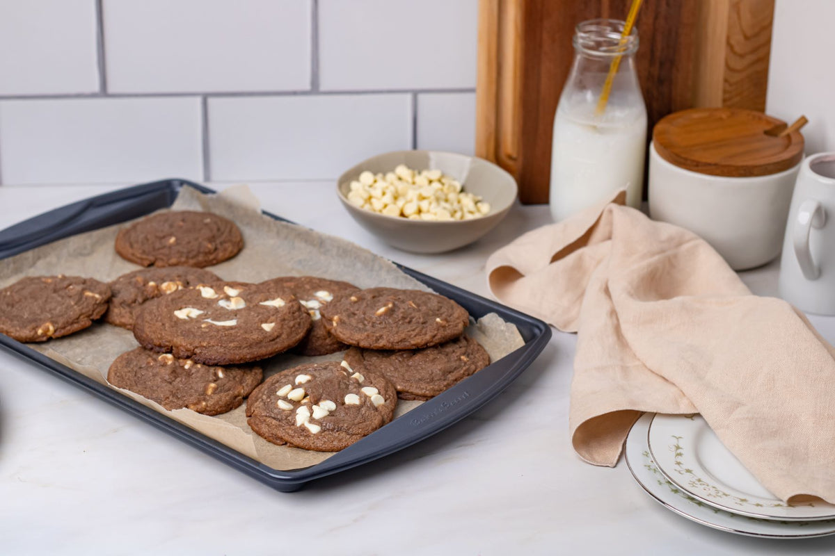 Inside out chocolate cookies with white chocolate chips on a cookie sheet
