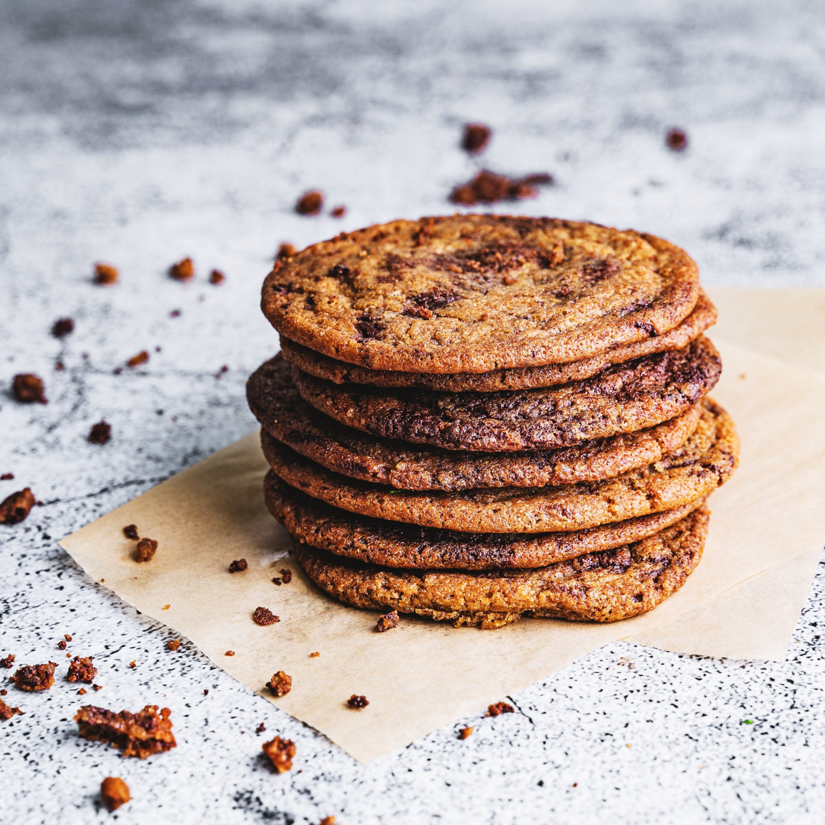 Stack of chocolate chip cookies on parchment