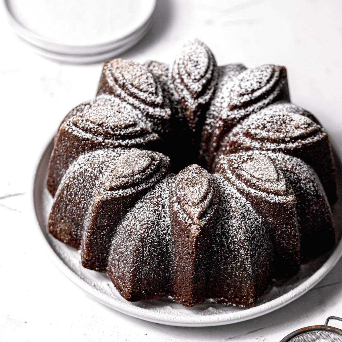 Chocolate Bloom fluted cake dusted with powdered sugar