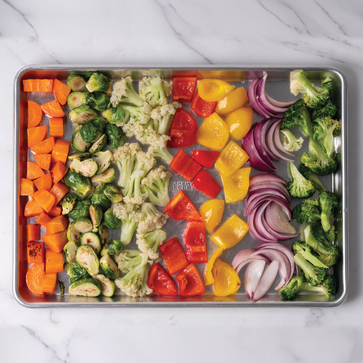 Roasted vegetables on a champagne-gold diamond-texture sheet pan