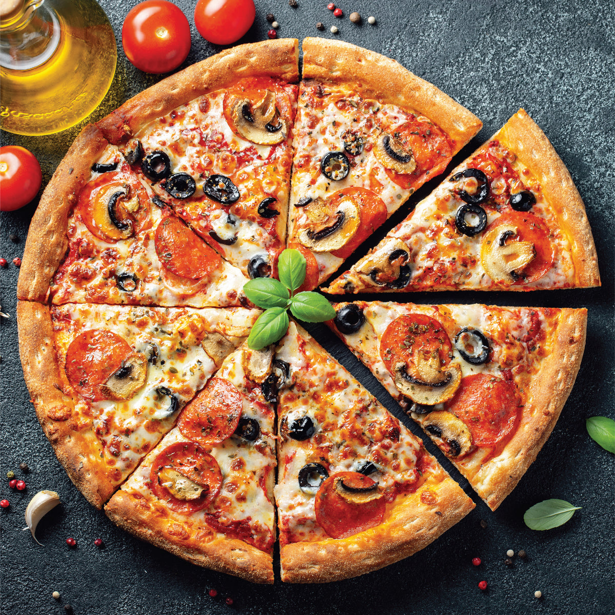 Sliced pizza with olives and tomatoes on a pizza crisper